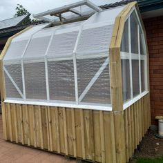 a small wooden building with a glass roof