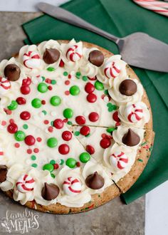 a cake with white frosting and candy toppings