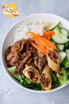 a white bowl filled with meat and veggies next to cucumber slices