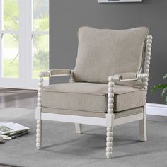 a living room with gray walls and a white chair in the middle of the room