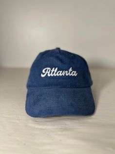 Ultra Soft and Durable Corduroy Hat with Atlanta embroidered on the front Adjustable Blue Corduroy Hat, Corduroy Baseball Cap With Embroidered Logo, Corduroy Hat With Embroidered Logo And Curved Brim, Casual Winter Hats With Letter Embroidery, Casual Corduroy Hat With Curved Bill, Casual Adjustable Hats With Embroidered Text, Casual Hat With Embroidered Text And Curved Brim, Adjustable Corduroy Hat With Embroidered Logo, Blue Cap With Letter Embroidery