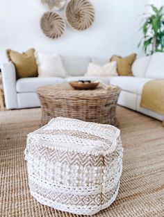 a living room with wicker furniture and white walls