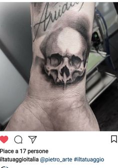 a man's hand with a skull on it and the words tattoo written in black ink