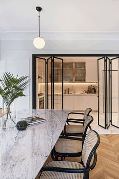 a dining room with marble table and chairs