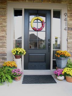 the front door is decorated with flowers and wreaths