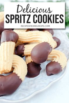 chocolate covered cookies on a plate with the words delicious spritz cookies