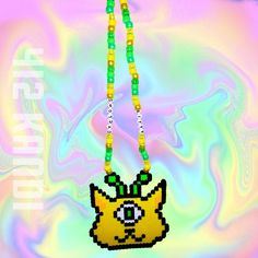 a beaded necklace with an image of a yellow cat on it's face