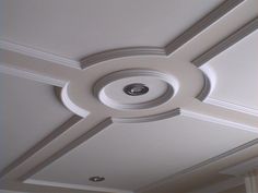 the ceiling is painted white and has a circular light fixture