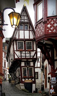 a cobblestone street in an old european town with half - timbered buildings