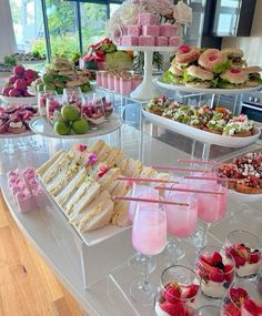 an assortment of desserts and pastries displayed on a buffet table