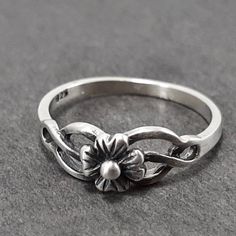 Sterling Silver Flower Ring, Flower ring Floral Ring, Floral Band, Dainty Ring, Pinky Ring   face height 5.5mm band thickness .75 mm band width 1.6mm Choose from High Polish, Satin or Oxidized finish. Some information on the Finishes. Oxidized Finish is dark grey/black and buffed to have some of the silver show through. This finish can wear over time from the friction of being worn and can eventually look more like a satin finish, unless reoxidized. Satin finish has a brushed non shiny look and Classic Adjustable Flower Ring, Classic Adjustable Flower Promise Ring, Silver Flower Ring, Baby Rings, Flower Band, Ring Flower, Zierlicher Ring, Claddagh Rings, Floral Ring