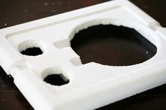 two holes in the side of a white plastic object