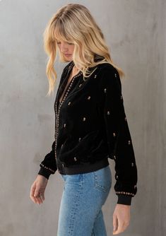 A cool and bohemian chic velvet bomber jacket, made for chilly days and nights. Featuring essential side pockets and floral beaded detailing throughout. Pair this super soft layering staple with jeans and a tee for an easy everyday look! Ultra-soft velvet Beaded detail Relaxed fit Long sleeves Hip length Zip front Side pockets Bohemian bomber jacket Model is 5'9, wearing a size S.Style: I-20137WL-QTR Black Velvet Outerwear For Fall, Bohemian Embellished Outerwear For Fall, Fall Bohemian Embellished Outerwear, Bohemian Sweater, Bohemian Chic, Sweater Shop, Everyday Look, Bomber Jacket, Coats Jackets