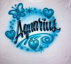 the word aquarius is painted on a white t - shirt with blue hearts and butterflies