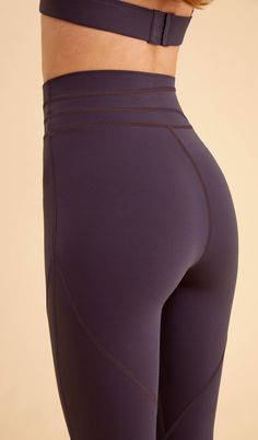 the back view of a woman's leggings in purple