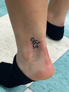 a woman's foot with a tattoo on her left ankle and the word love written in cursive font