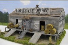 a model of a building with hay bales on the roof and steps leading up to it