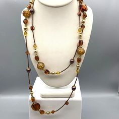 Super Long Bronze Beaded Vintage Necklace, Flashy Art Glass Stations on Seed Bead Strand, Bronze and Gold Tone Measurement * 49" unsigned infinity style (no clasp) Condition * Very nice condition. Gently used. Size: Womens 49" Condition: Pre-Owned Good Amber Beaded Long Necklace, Adjustable Beaded Necklace With Large Beads For Party, Brown Beaded Multi-strand Jewelry, Brown Multi-strand Beaded Necklace With Gold Beads, Brown Gold Beads Multi-strand Necklace, Adjustable Long Necklace With Colorful Beads, Colorful Round Bead Long Necklace For Parties, Colorful Round Beads Long Necklace For Party, Adjustable Beaded Chain Long Necklace For Beach