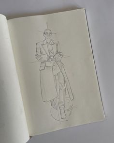 an open book with a drawing of a man in a trench coat