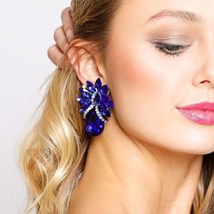 Description Meant to be oversized and extravagant, these teardrop stone clip-on earrings are the perfect way to make waves in the fashion world. Large statement clip-on earrings with a tropical inspired design, lined with bright, sparkling royal blue stones and silver plating. Beautiful, shiny, sophisticated jewelry to add towards your accessories collection. Size • Clip-on earrings.• Length: 2.25 in (5.72 cm)• Width: 2.75 in (6.99 cm) Quality Made from high-quality lightweight, solid metal allo Party Teardrop Crystal Clip-on Earrings, Party Teardrop Clip-on Crystal Earrings, Clip-on Teardrop Earrings For Party, Blue Teardrop Earrings For Party, Blue Party Clip-on Earrings, Blue Clip-on Earrings For Evening, Sophisticated Jewelry, Pearl Shop, Make Waves