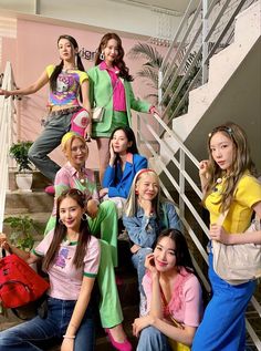 the girls are posing on the stairs together