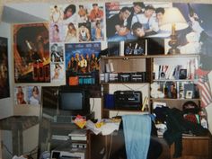 a cluttered room with posters and pictures on the wall