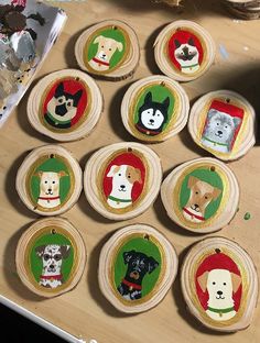 wooden ornaments with dogs on them sitting on a table