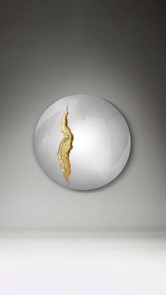 an oval shaped object with gold paint on it