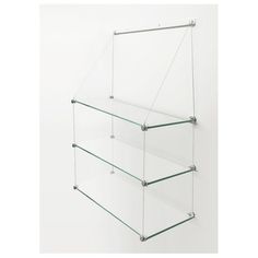 three glass shelves are hanging on the wall