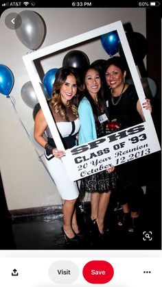 two women holding up a sign with balloons in the background that says class of 2013