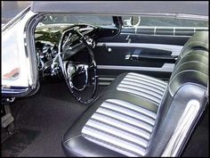 the interior of a classic car with black leather seats