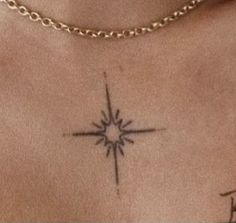 a woman's chest with a star tattoo on her left side ribcage