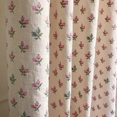 the curtains are decorated with pink flowers and green leaves