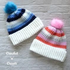 two knitted hats with pom - poms on them