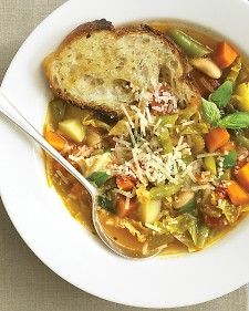 a white bowl filled with soup and bread