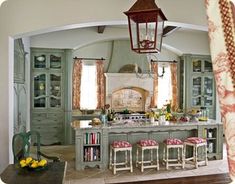 a large kitchen with an island and lots of stools in front of the stove