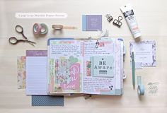 the contents of a scrapbook laid out on a wooden table with scissors, tape and other items