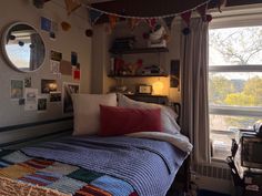 a bedroom with a bed, desk and window