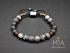 "Larvikite & Black Lava Raw Bead Bracelet Copper Hematite Stone Macrame Bracelet Men's And Women's Gemstone Jewelry Women's Size: 6\" - 7.5\" ( 15.2 cm -19.1 cm ) Men's Size:      7\"-8.5\"  ( 17.8 cm - 21.6 cm ) Made of 8 mm naturalLarvikite beads, 8 mm natural Lava Beads, and 6 mm natural copper hematite Beads. All finished with black nylon cord, at the ends I used 4 mm Hematite Stone beads. - The bracelet is adjustable (it could be made in any size). Other Designs  www.etsy.com/shop/minejewelleryart Larvikite ♥ Grounding ♥ Protective ♥ Patience Larvikite is a protective and grounding stone.  It is cleansing to the subtle bodies and facilitates a strong connection with the energies of Earth, helping to connect with the spirits of Nature.  Larvikite stimulates inner visions and enhances o Handmade Adjustable Lava Stone Beaded Bracelets, Elegant Black Lava Stone Beaded Bracelets, Adjustable Black Lava Stone Beaded Bracelets, Mens Lava Bead Bracelet, Stone Macrame, Casual Hand-strung Lava Stone Beaded Bracelets, Lava Bead Bracelet, Black Bracelet, Hematite Stone