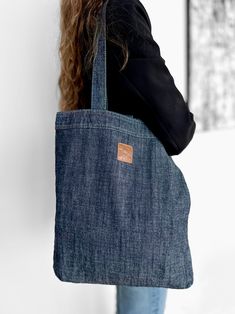 "Discover the perfect blend of style and functionality with our handmade Foldable Denim Tote Bag.  This Shopper Jeans is not just a bag, it's a portable, reusable companion designed for your on-the-go lifestyle. Handcrafted with care, our denim tote bag is not only fashionable but also eco-friendly. The foldable design makes it easy to carry and store, ensuring you're always prepared for your shopping needs. The sturdy denim material ensures durability, making it your reliable folding shopping sack. Ideal for the environmentally conscious shopper, our portable reusable bag is a sustainable choice that doesn't compromise on style. Take it with you wherever you go - its travel-friendly design makes it perfect for spontaneous outings. Embrace the convenience of our Folding Shopping Sack and m Foldable Shopping Bag, Denim Tote Bags, Jeans Fabric, Tote Bags Handmade, Denim Tote, Large Handbags, Denim Material, Reusable Grocery Bags, Shopper Tote