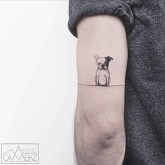 a small dog tattoo on the left inner arm, with an instagram message below it