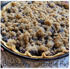 a blueberry crumble pie sitting on top of a table