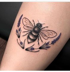 a black and white photo of a bee with lavenders on it's thigh