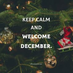 a christmas tree with ornaments hanging from it and the words keep calm and welcome december