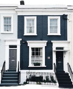 a row of houses with black and white trim