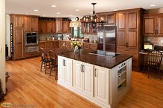 a large kitchen with wooden floors and cabinets