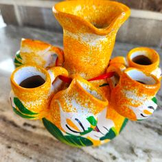 an orange vase sitting on top of a table