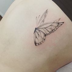 a black and white butterfly tattoo on the stomach