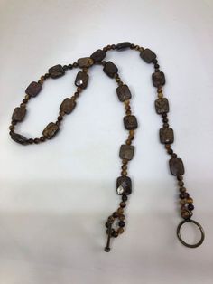 Faceted Bronzite and tigers eye round beaded necklace with bronze toggle clasp Brown Necklace With Round Beads And Lobster Clasp, Brown Round Necklace With Lobster Clasp, Eye Round, Unisex Necklace, Ball Necklace, Modern Urban, Tigers Eye, Beaded Necklaces, Disco Ball