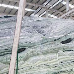 a large green marble slab in a warehouse